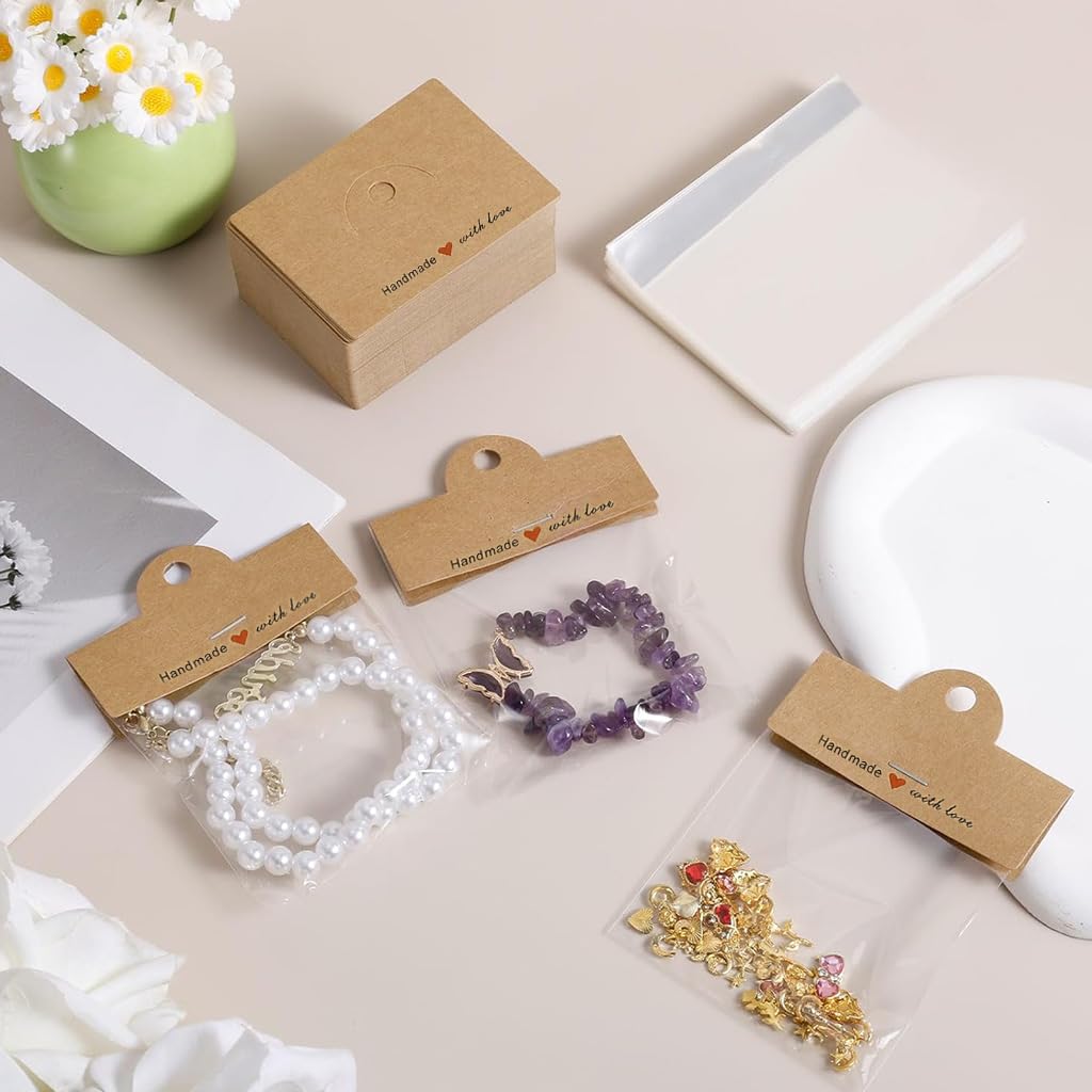 HASTHIP Jewellery Organiser Pouch Set for Rings and Necklaces with 100Pcs 8x10cm Clear Bags | Includes Brown Cardstock Handles for Display and Gifting